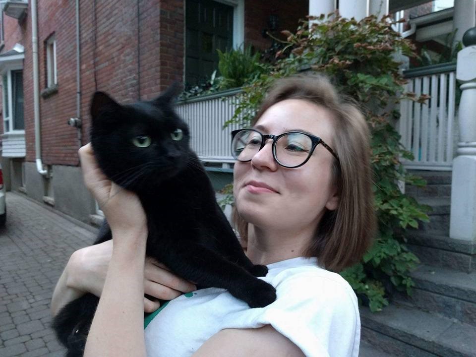 Julia Pyryeskina holding a black cat