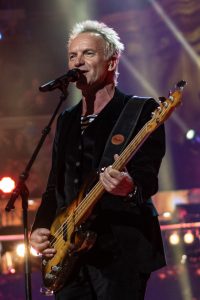 Photo of Sting playing guitar.