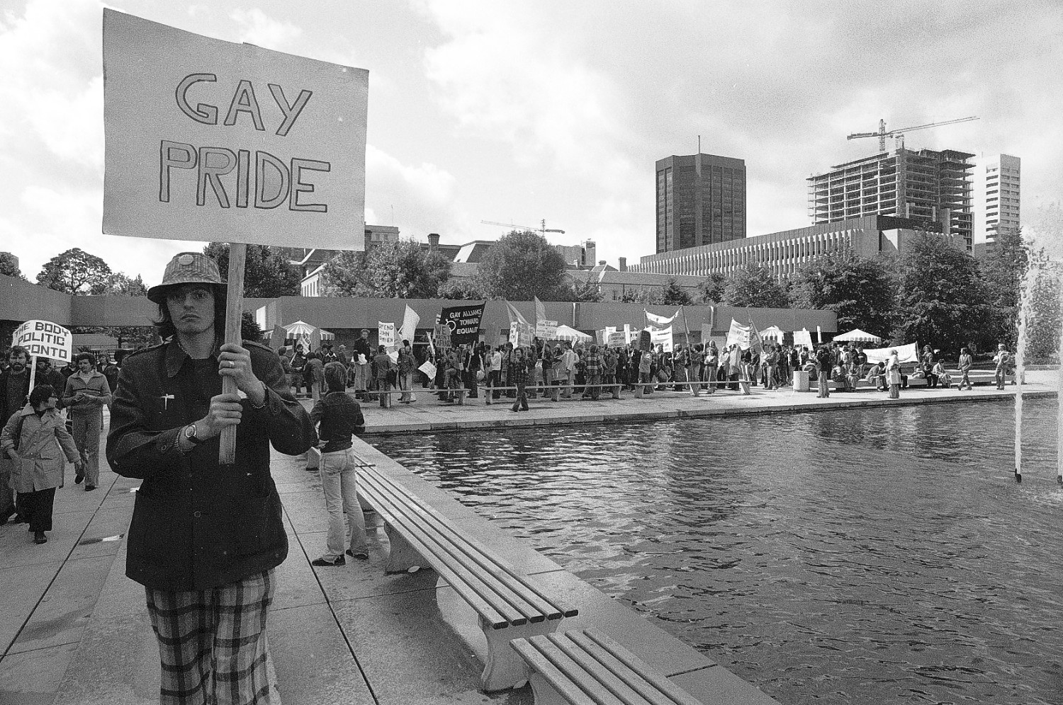 Black and white photo of man with sign.